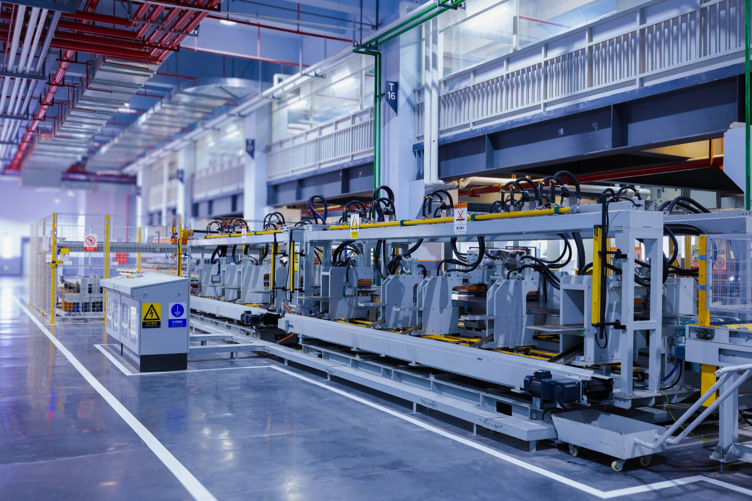 Automated production line inside a bright, modern factory hall