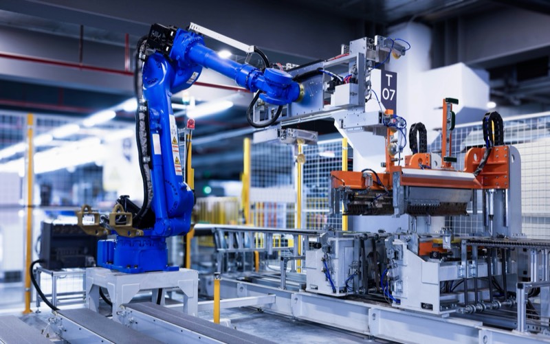 Industrial robot arm working inside an automated production cell
